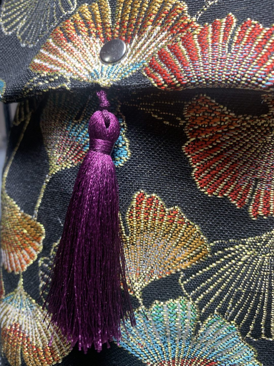 GINGO FLAP BAG WITH PURPLE TASSELS